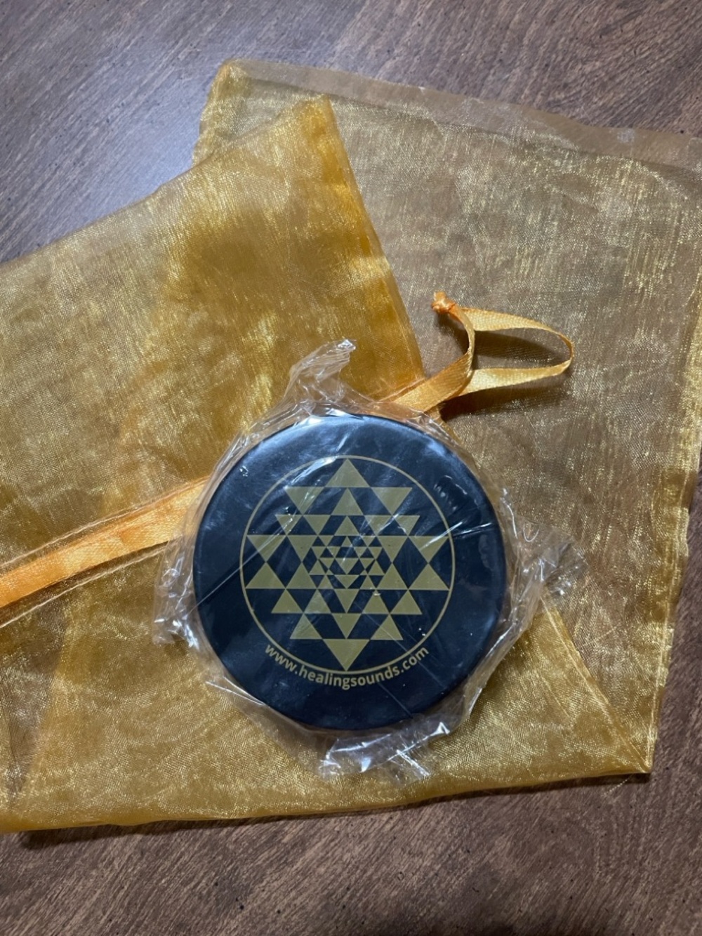 Round Black Puck with Geometric Gold Design